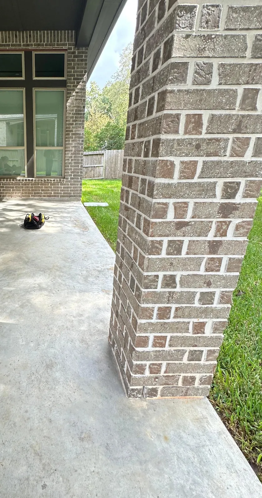 Bare concrete covered patio slab before epoxy flake coating