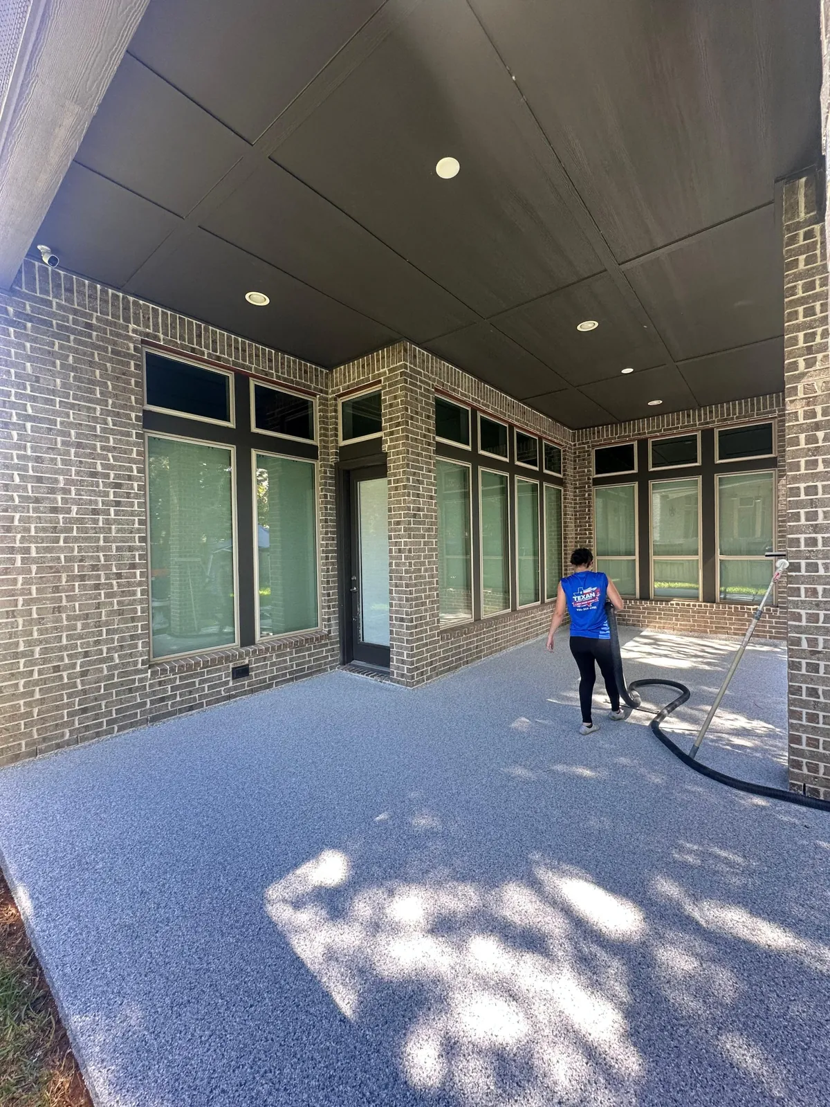 Texan Epoxy crew member on a finished epoxy flake patio