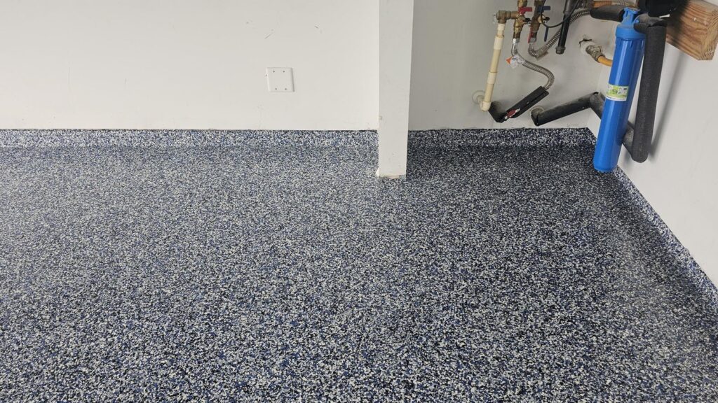 Orbit Flake System epoxy garage floor with cove base along the wall