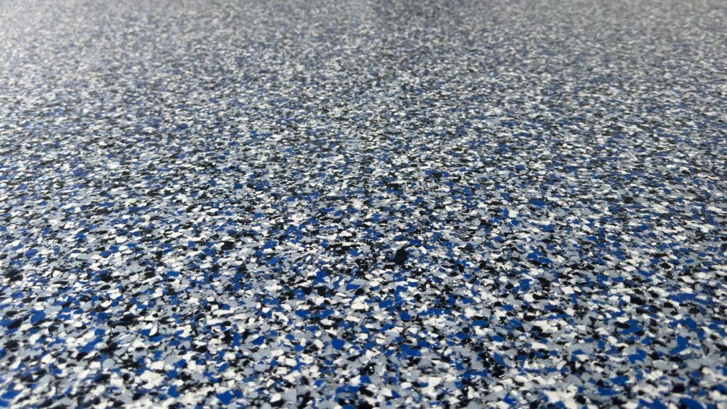 Close-up of an Orbit Flake System epoxy garage floor