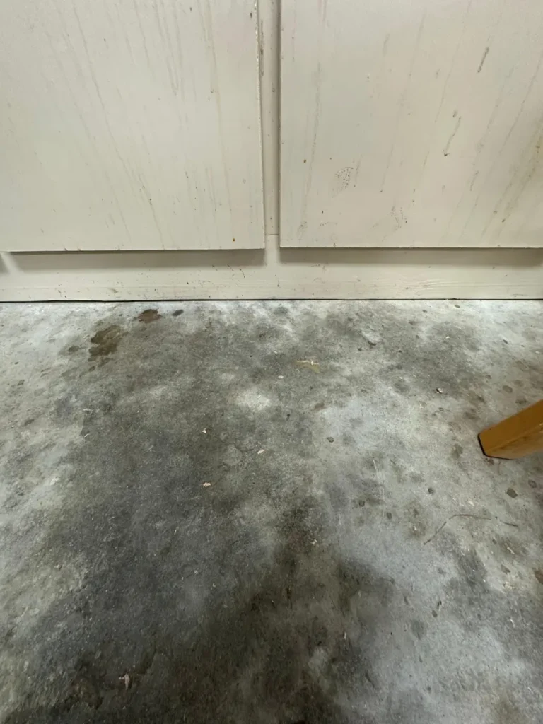 Oil-stained concrete garage floor before epoxy coating
